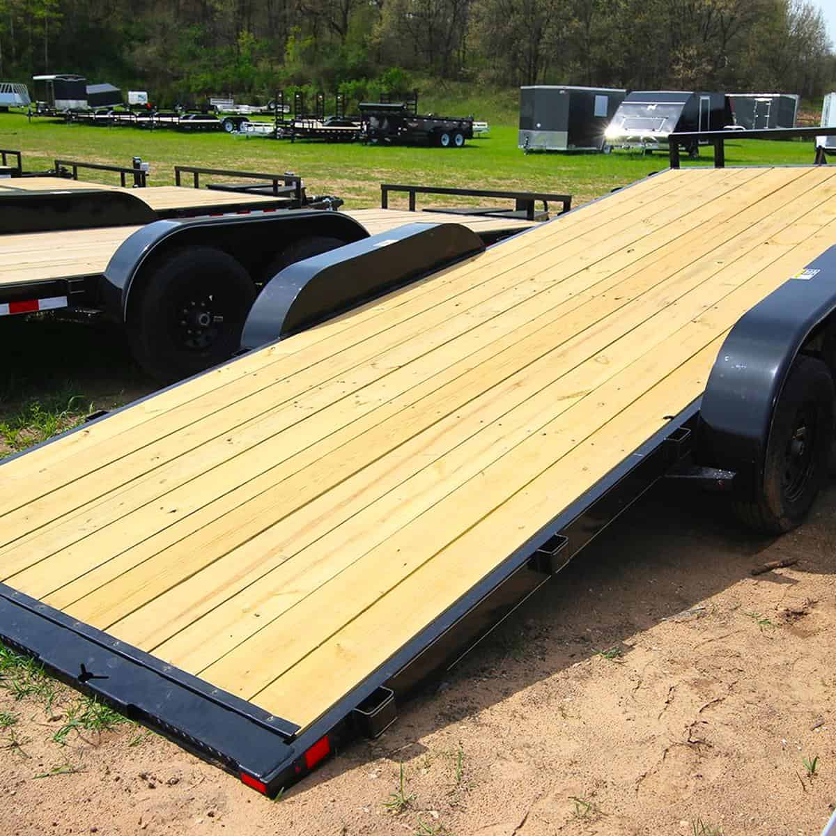 Heavy-duty flatbed trailer with wooden deck at I39 Supply trailer dealership, showcasing durable construction and versatile utility trailers for sale.
