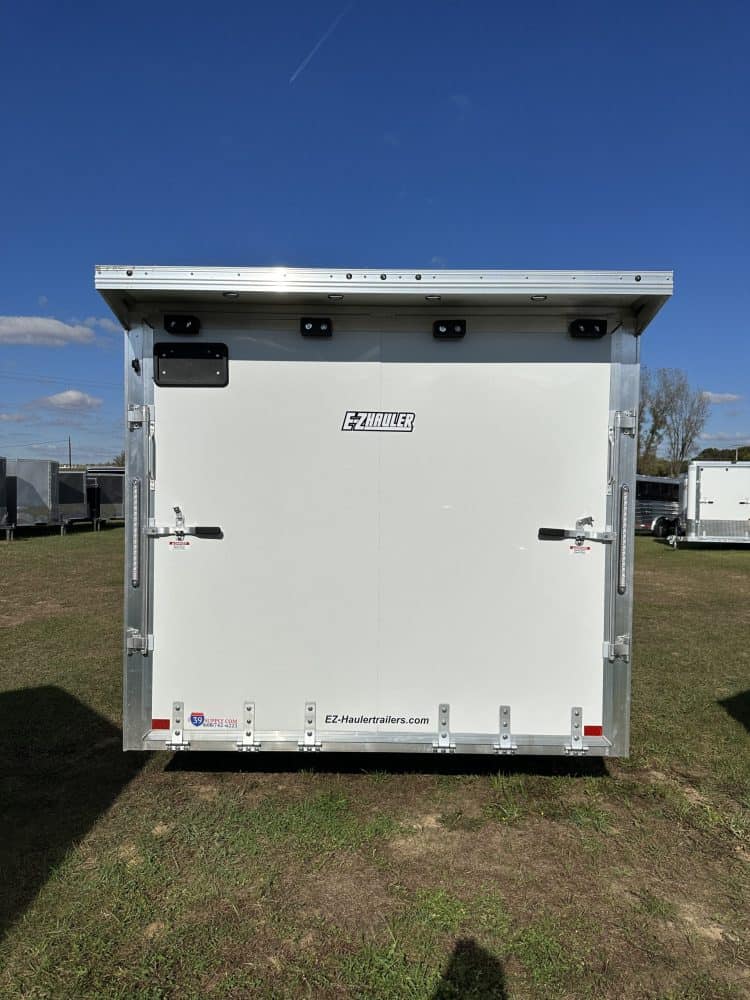 EZ Hauler enclosed trailer for car transport, featuring durable construction and secure locking mechanisms. Perfect for vehicle enthusiasts and professional dealerships.