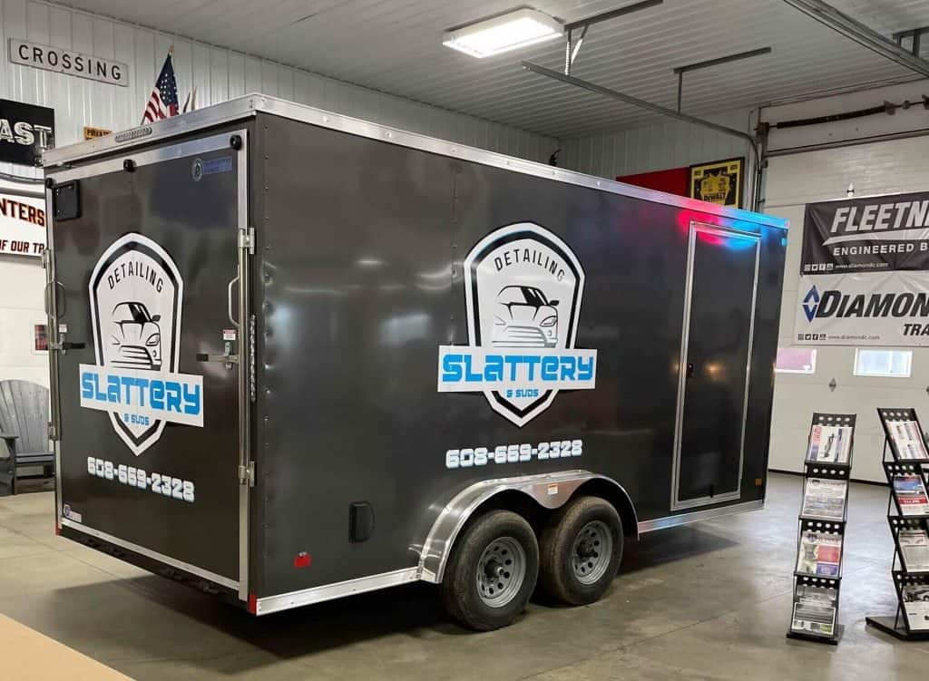 Trailer for sale at I39 Supply, showcasing a sleek black design with Slattery Detailing logos, perfect for mobile detailing or transport needs.