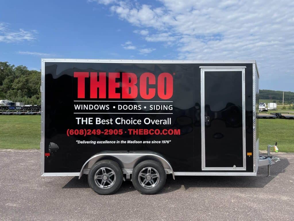 Trailer with Theco branding, showcasing windows, doors, and siding options for commercial or personal use.