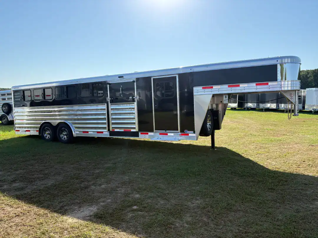High-capacity 2026 Exiss 8x26 aluminum livestock trailer with gooseneck design, rear and side ramps, and a spacious tack room, ideal for efficient livestock transportation.