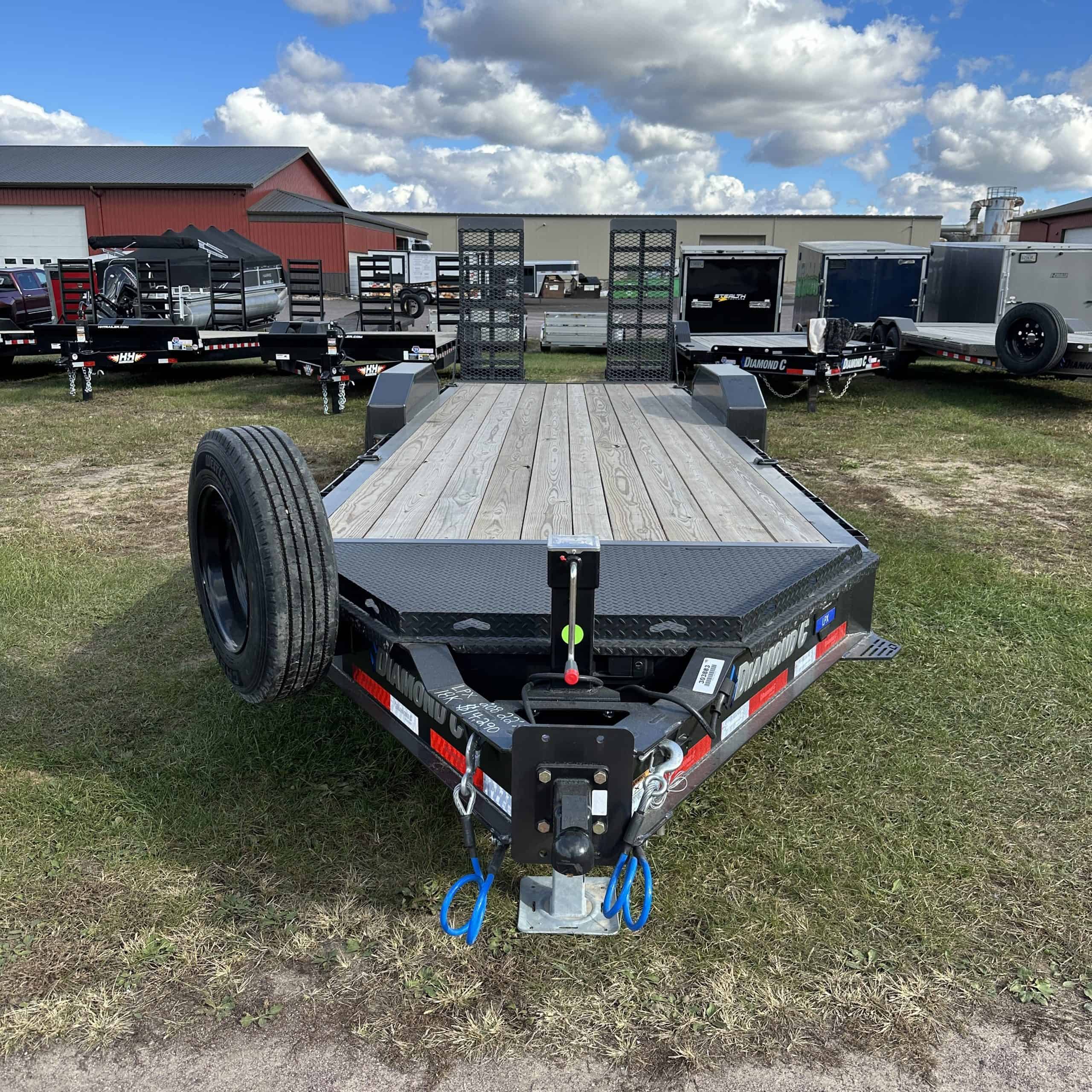 An industrial-grade flatbed trailer with a durable steel frame, 22x82 inch deck, and 18,000 lbs weight capacity, ideal for heavy-duty hauling and equipment transport.