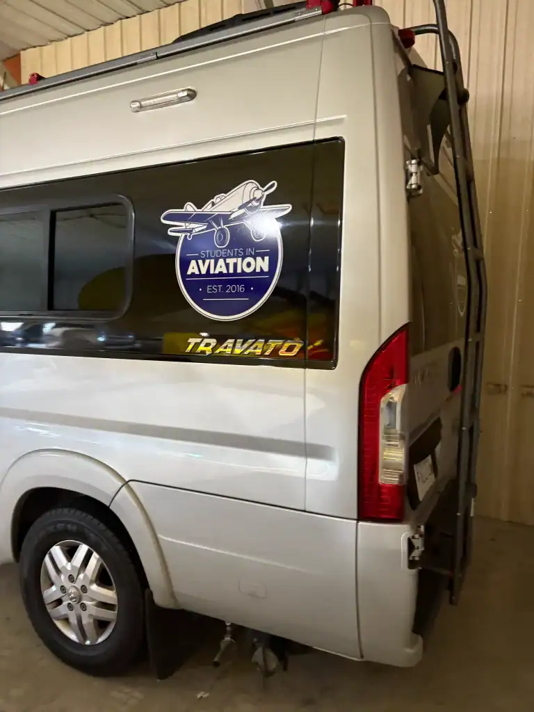 Commercial van with Student Aviation logo and TraVato branding, showcasing aviation-themed trailers available at I39 Supply, a trusted dealership for high-quality trailers.