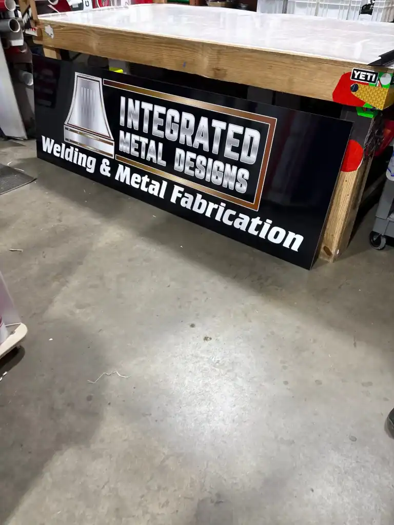 Custom welding and metal fabrication sign displayed at I39 Supply Trailer Dealership, showcasing integrated metal design services for trailers and equipment.