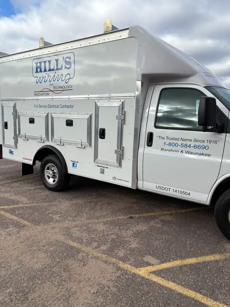 Service truck from Hill's Wiring with electrical compartments, parked in a lot, showcasing reliable electrical contractor services.