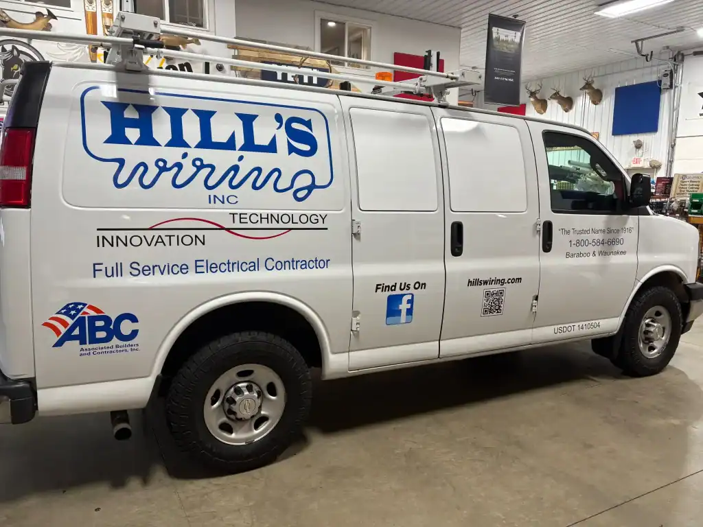 White service van for Hill's Wiring Inc. showcasing electrical contracting services at I39 Supply Trailer Dealership.