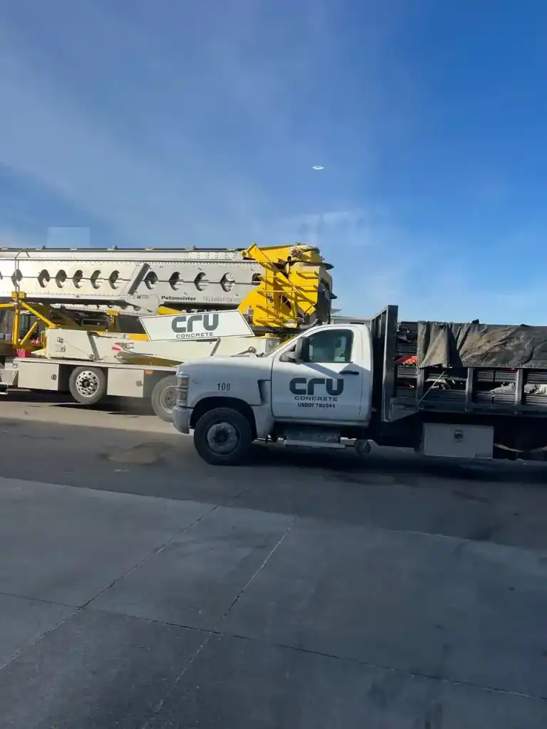 Construction trailer and equipment transport truck with crane at I39 Supply trailer dealership.