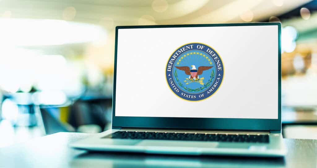 Government Community Cloud High logo on a laptop screen, emphasizing secure cloud services.