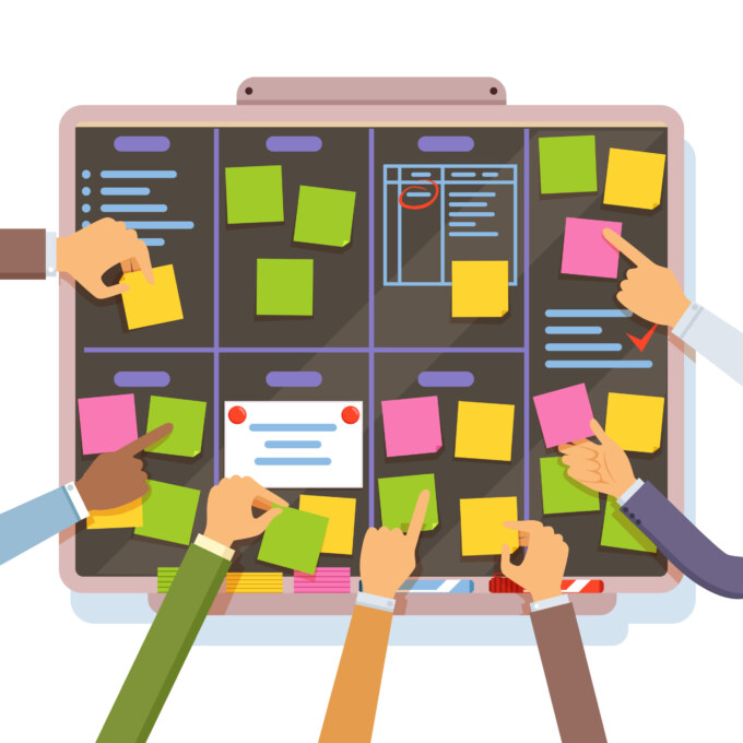 Agile team collaborating with sticky notes on a planning board.