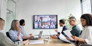 Business meeting with remote team members discussing vendor management.