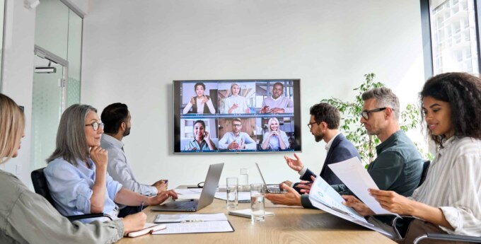 Business meeting with remote team members discussing vendor management.