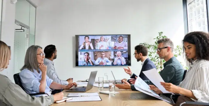 Business meeting with remote team members discussing vendor management.