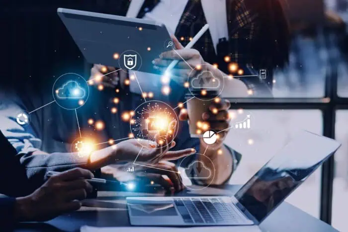 Business professionals analyzing IT systems with cloud and data icons for digital transformation.