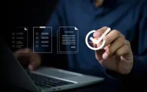 Business professional analyzing IT systems with digital icons and checklist.