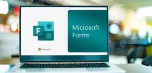 Laptop displaying Microsoft Forms logo for online surveys and data collection.
