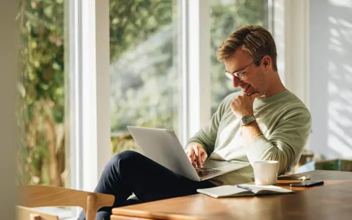 Business professional using laptop for Excel and Power Platform comparison.