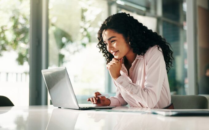 Businesswoman analyzing data integration risks on her laptop.