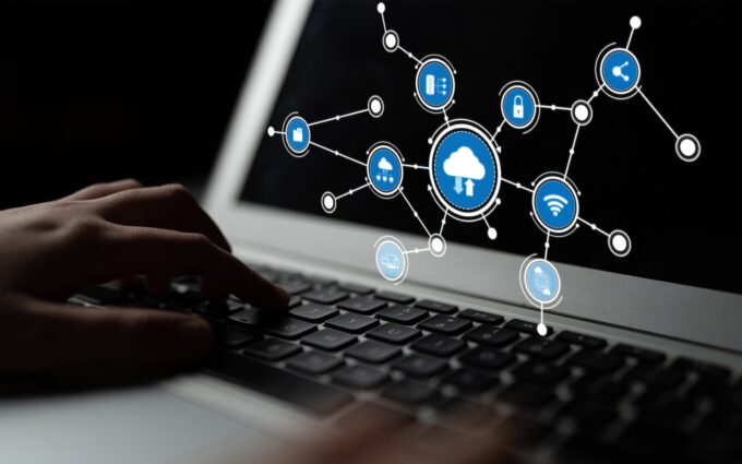 Cloud computing network with security icons on a laptop screen.