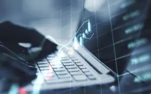 Business analytics and data visualization on a laptop with digital graphs.