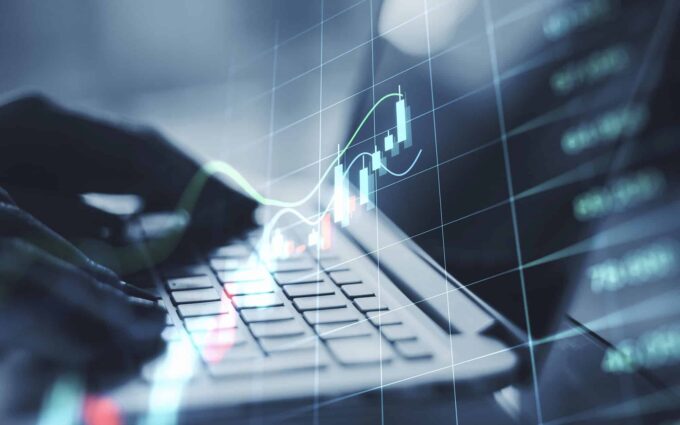 Business analytics and data visualization on a laptop with digital graphs.