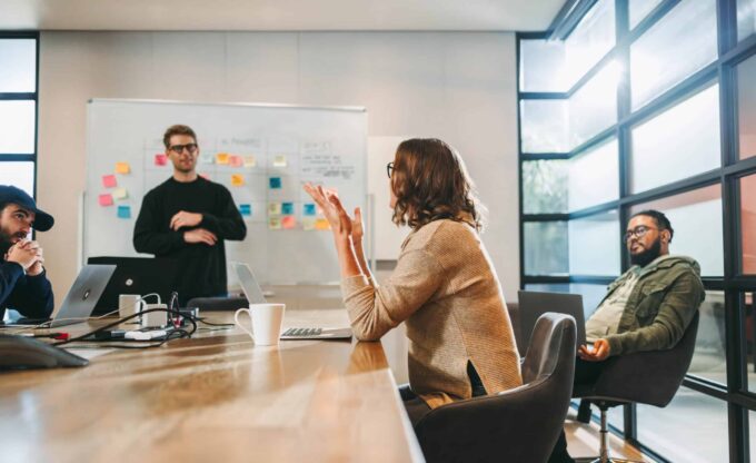 Business team discussing IT strategies in a modern conference room.