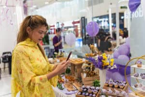 a lady is taking photo of the dessert table