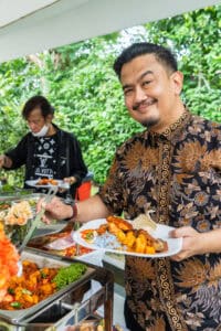 Guests happily choosing malay cuisines at buffet catering for malay wedding 