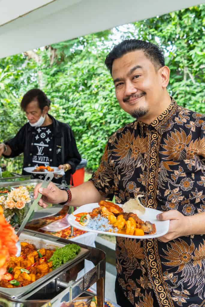Guests happily choosing malay cuisines at buffet catering for malay wedding 