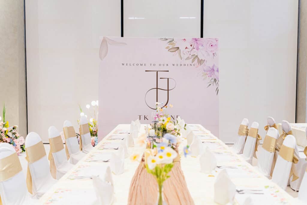 Elegant and sophisticated white floral wedding table and backdrop setup by iDoCatering