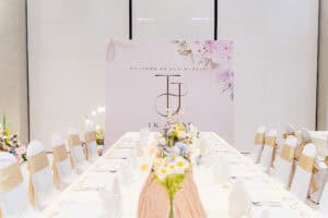 Elegant and sophisticated white floral wedding table and backdrop setup by iDoCatering