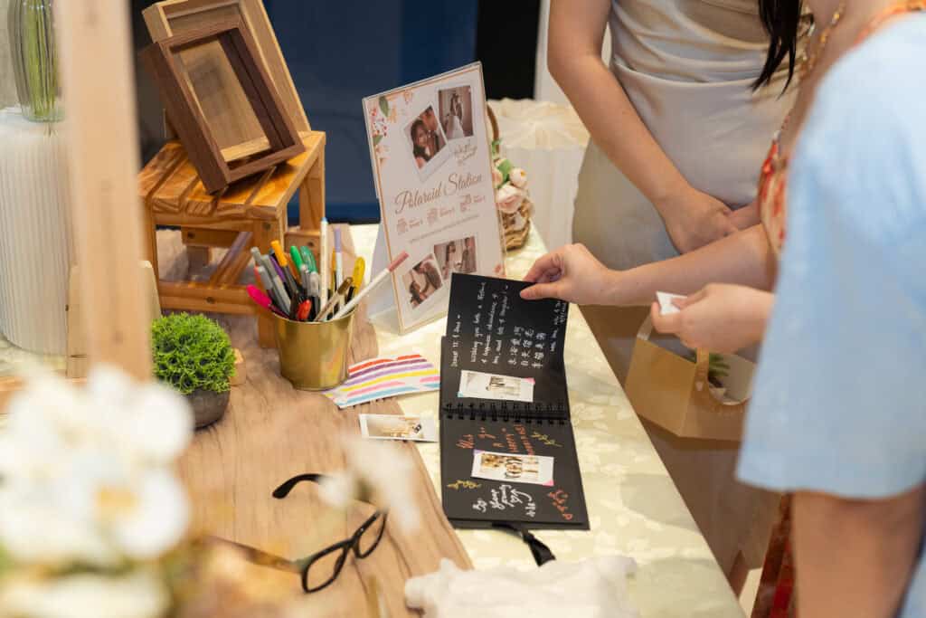 Creative polaroid and leave a message station for bride and groom newlyweds at wedding catering reception event by iDoCatering