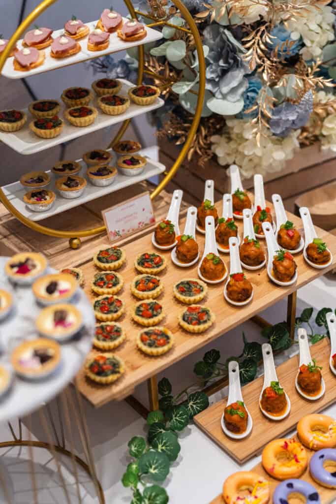Tarts, vegetarian pie and napolitan meatball on wooden plate for wedding canape catering