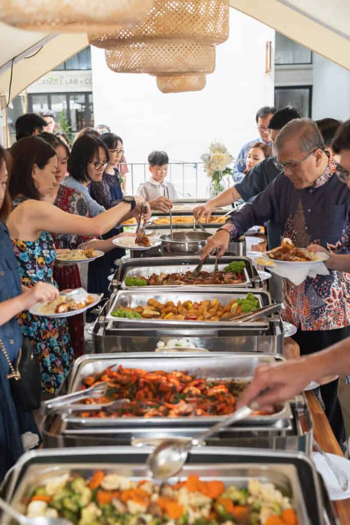 Guests enjoying wedding catering food by idocatering 