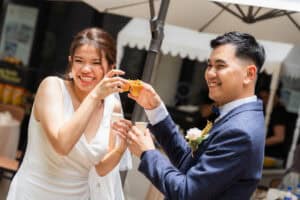 Bride and groom smiling towards the camera during a wedding catering event at Cyberjaya 