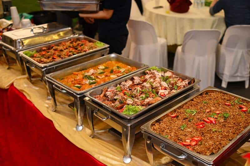 A generous row of chafing dishes with fried anchovies, curry, roasted chicken and fried rice, a signature of the premium Kemerdekaan Grand spread