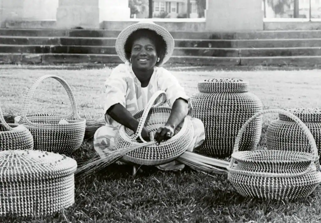 Black and white historical photo of artist with urns