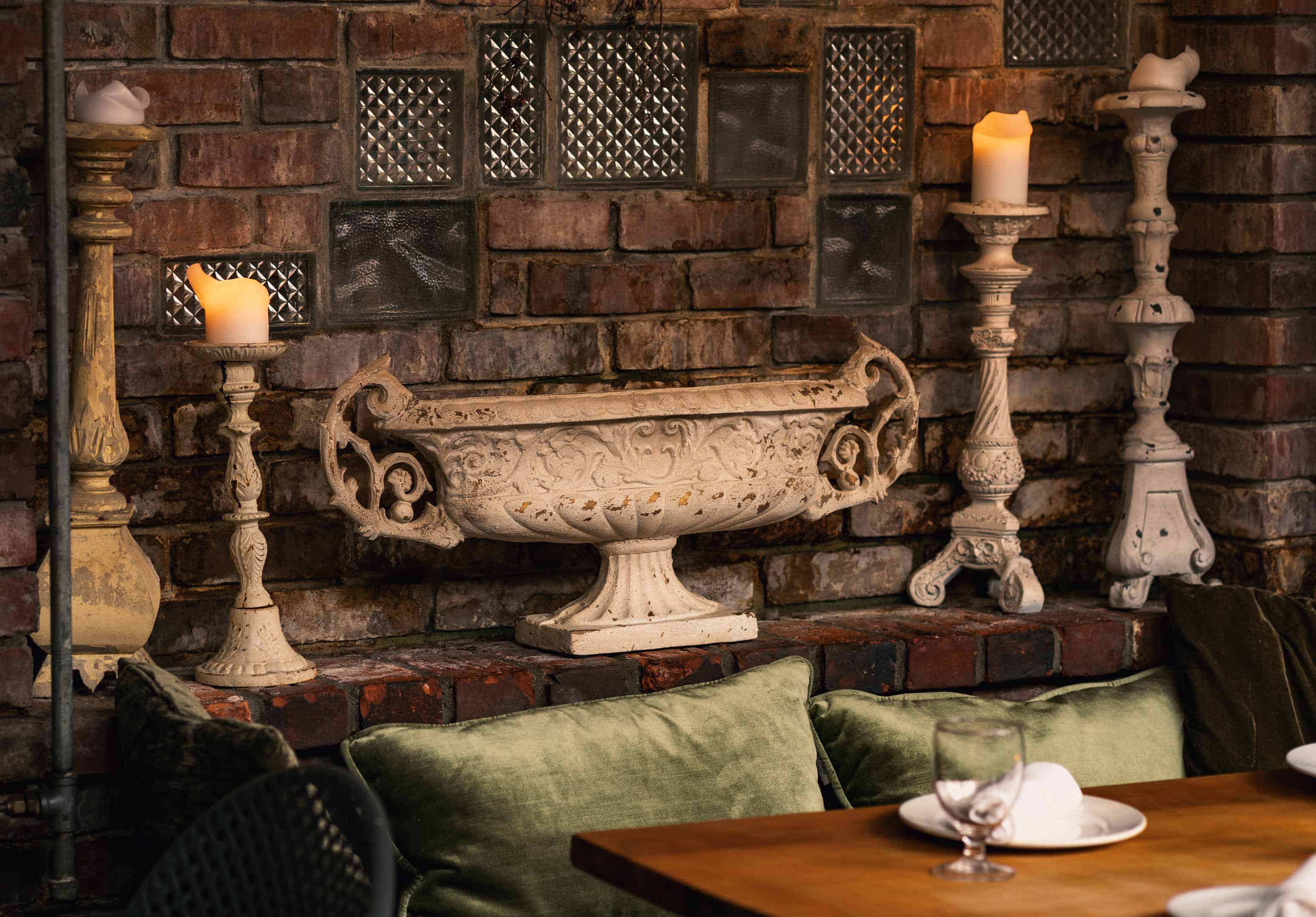 Elegant interior with terrazzo decor and vintage candle holders.