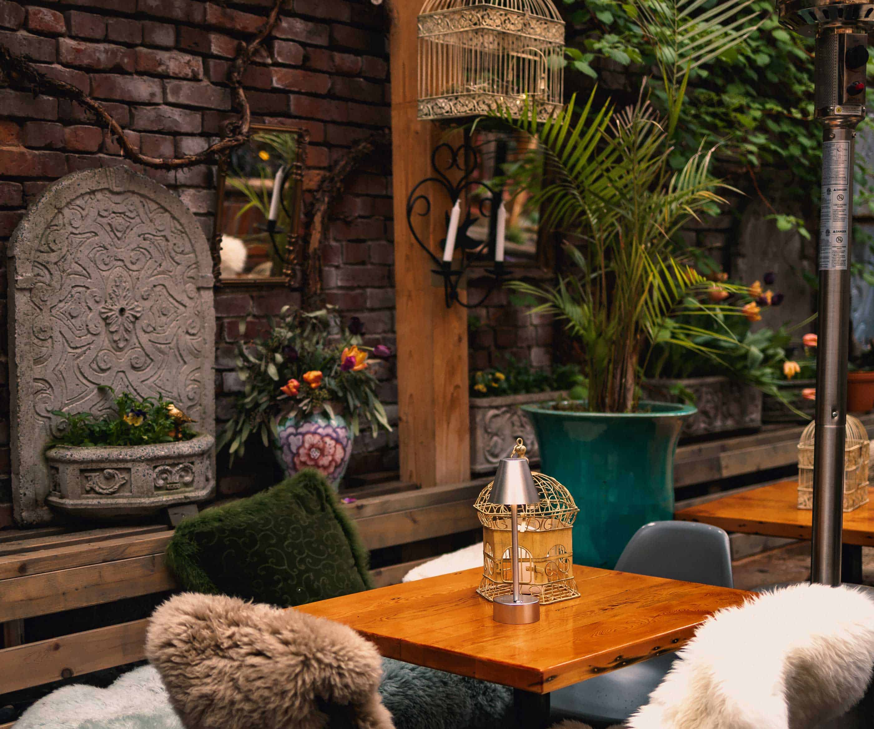 Chic outdoor dining space with lush plants and cozy seating at Il Terrazzo.
