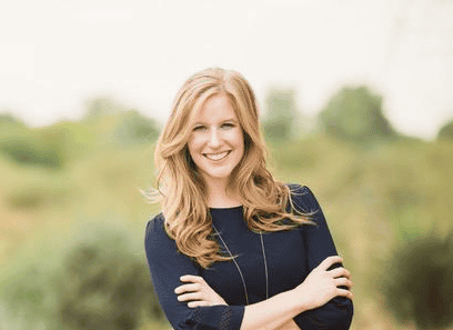 Smiling woman outdoors representing physical therapy services.