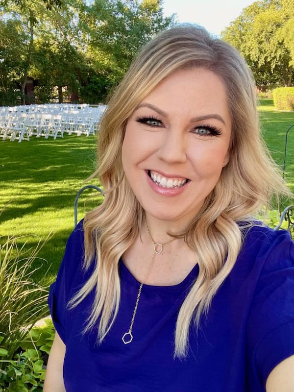 Nicole Fisk smiling outdoors at Impact Physical Therapy event.