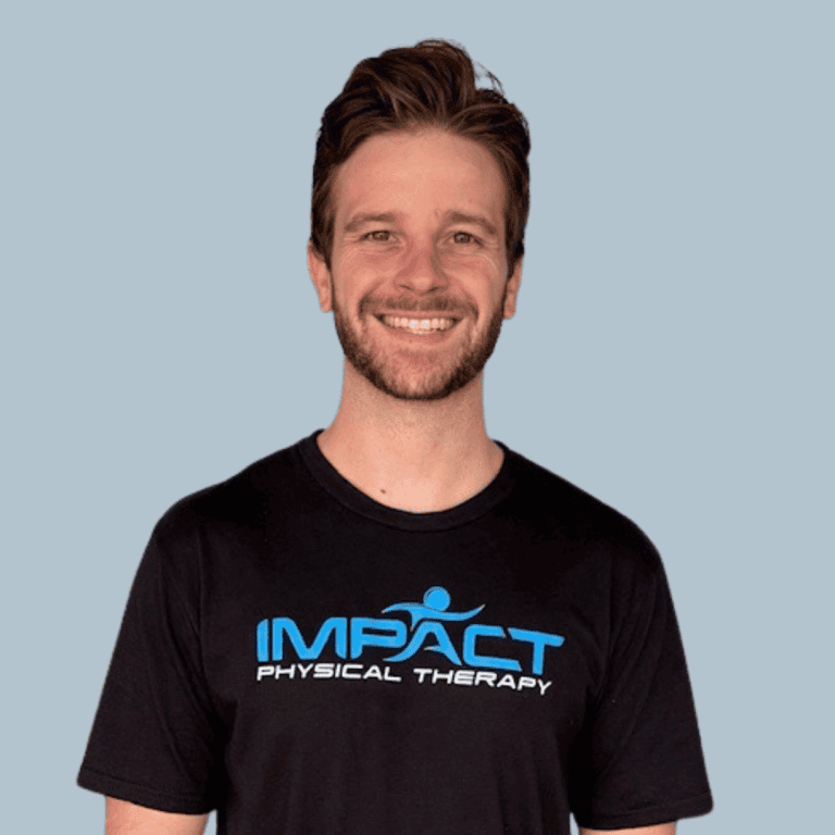 Dr. Graham Leonard wearing Impact Physical Therapy t-shirt smiling.