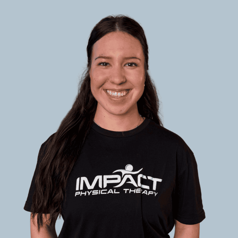 Smiling woman in Impact Physical Therapy T-shirt for health and wellness.