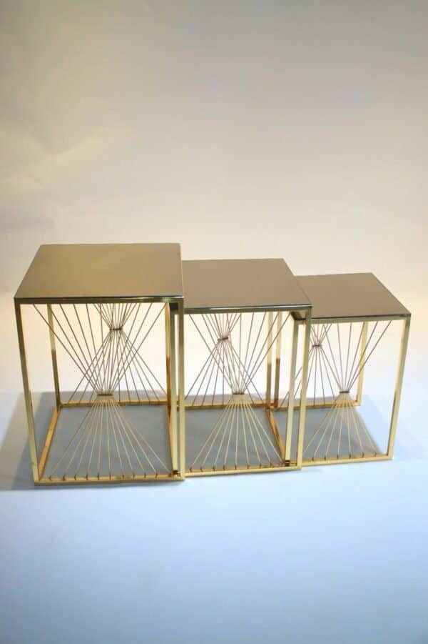Three Gold Nesting Tables With Square Tops And Decorative Metal Wire Sides, Varying In Height.