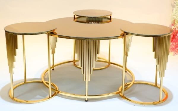 Gold Nesting Tables With Mirrored Tops, Decorative Vertical Accents, Arranged In A Tiered Design.