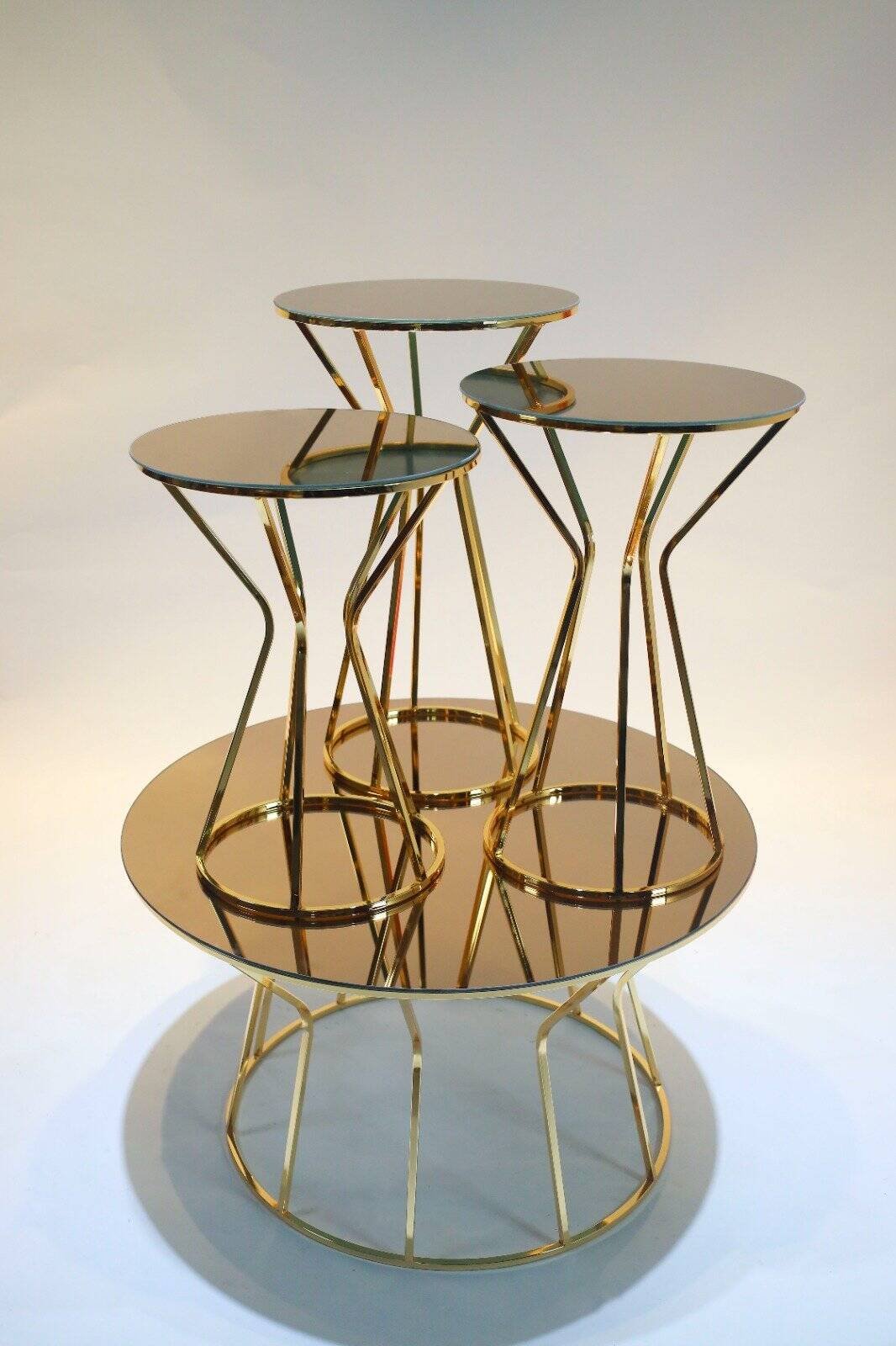 Modern Round Tables With Gold Frames And Reflective Surfaces, Arranged In A Nested Design.