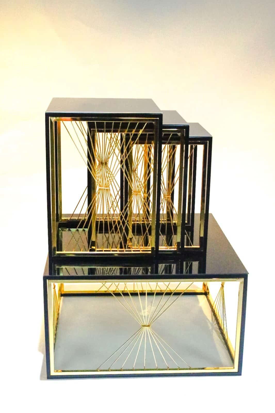 Nested Black Rectangular Frames With Gold Accents And Geometric String Patterns.