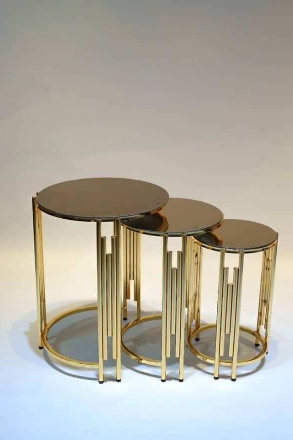 Three Nested Round Tables With Gold Frames And Dark Reflective Tops, Varying In Size.