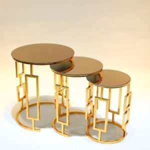 Three nested round tables with mirrored tops and gold geometric bases of varying heights.