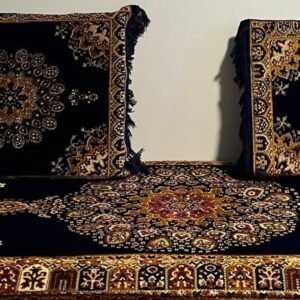 Two patterned cushions against a wall, with a matching textile floor covering.