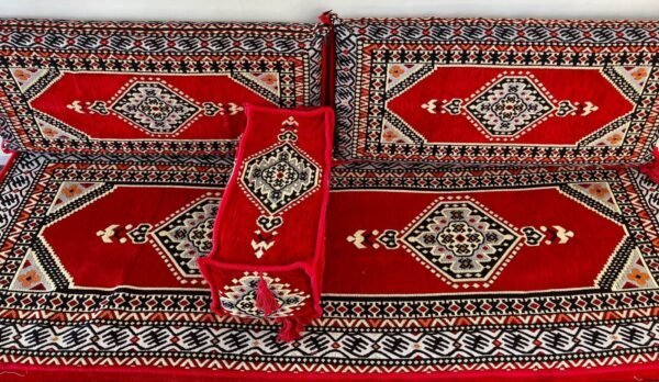 Red And Black Cushions With Geometric Patterns And Intricate Symmetrical Designs.